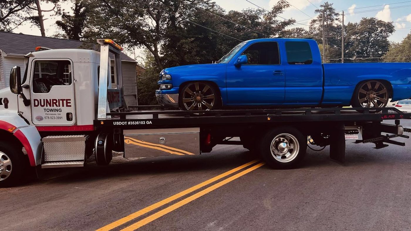 Pickup loaded on a Dunrite flatbed